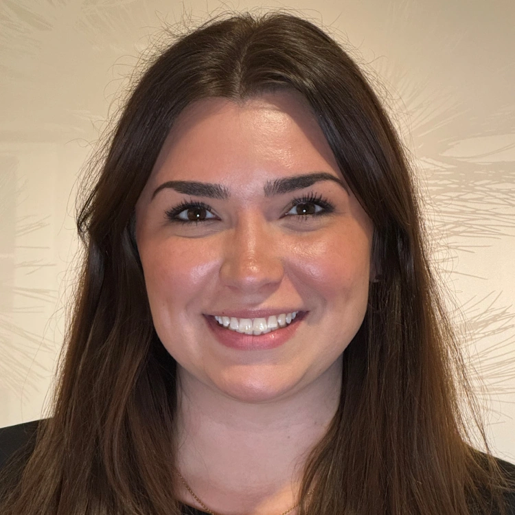 Young woman smiling at camera, professional headshot for dental practice website.